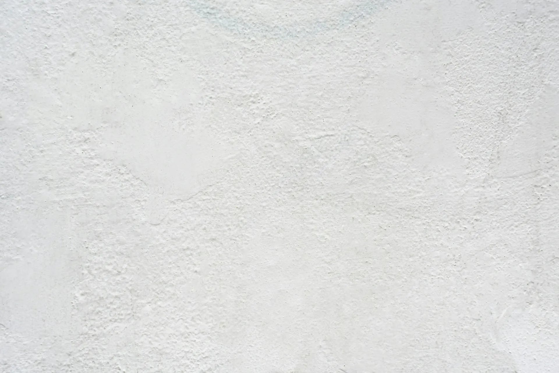 White textured background with a subtle plaster or concrete finish.