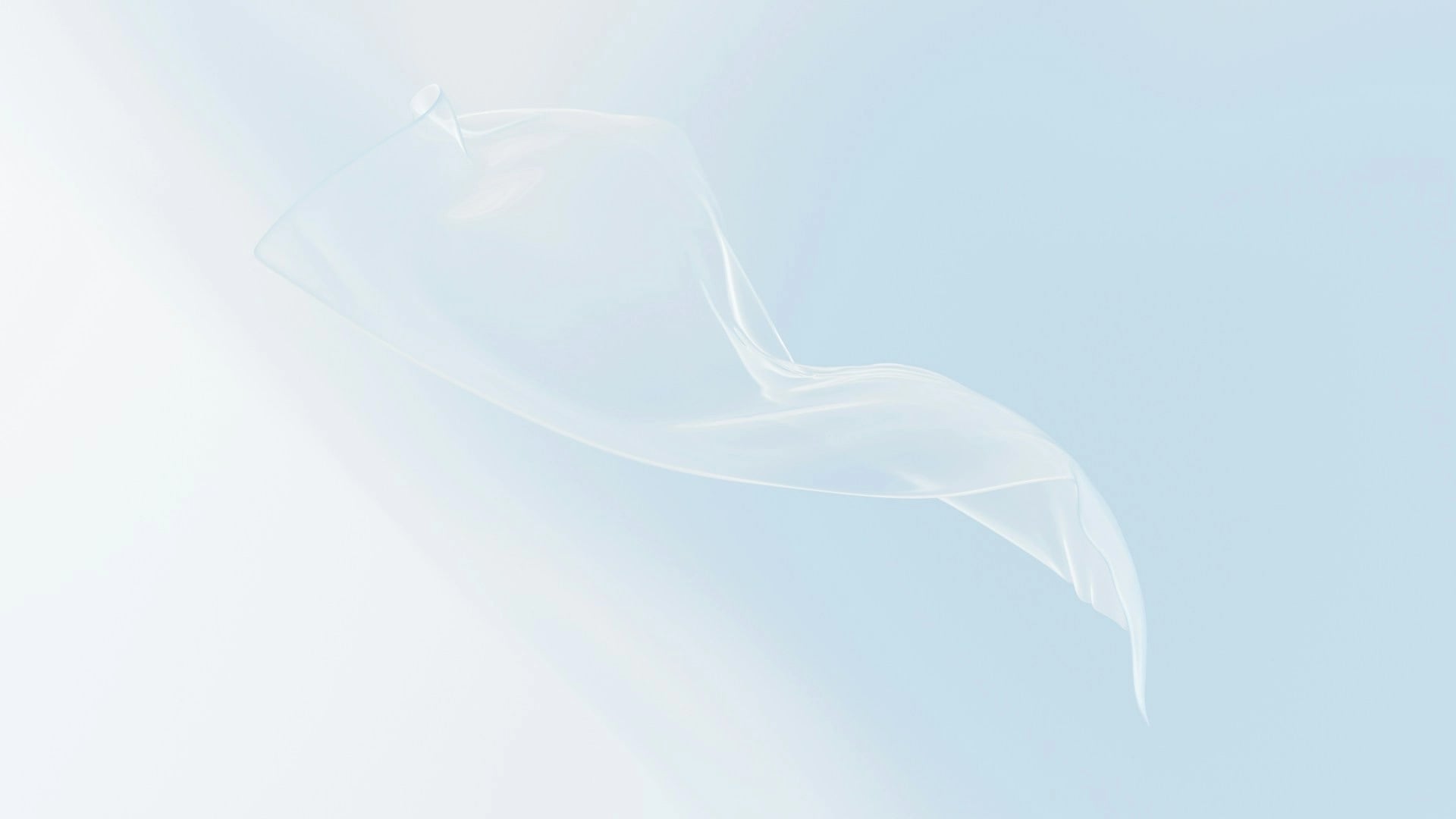 Transparent floating shape over soft blue background symbolising clarity, UX, and interface design in websites.