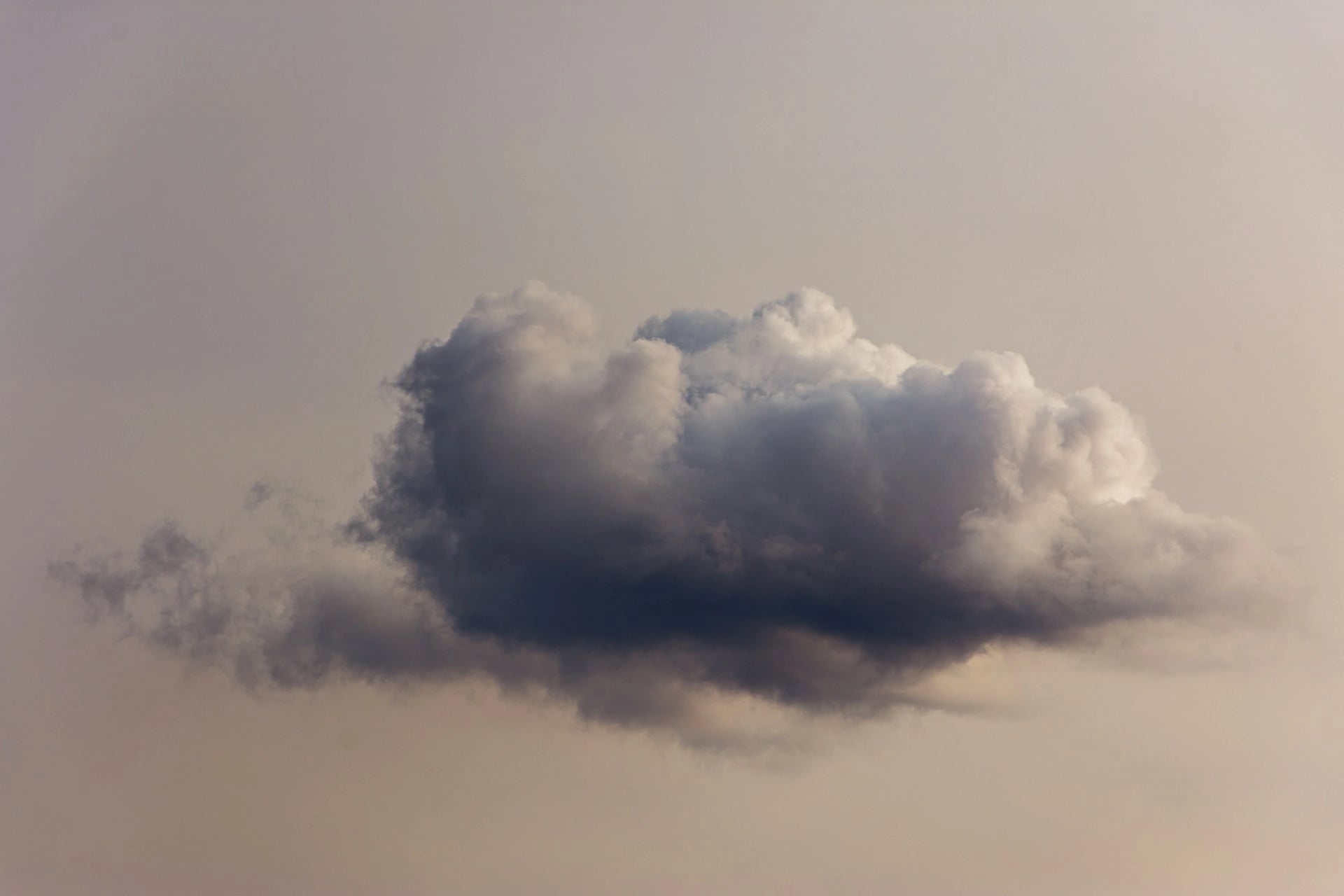 Single grey cloud in the sky against a neutral background.