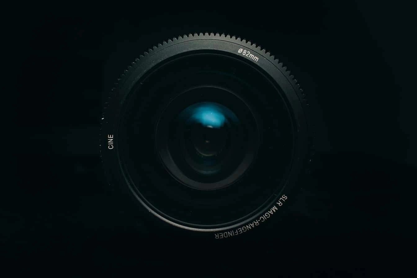 Detailed view of a cine camera lens marked "82mm" and "SLR Magic Rangefinder" against a dark background.
