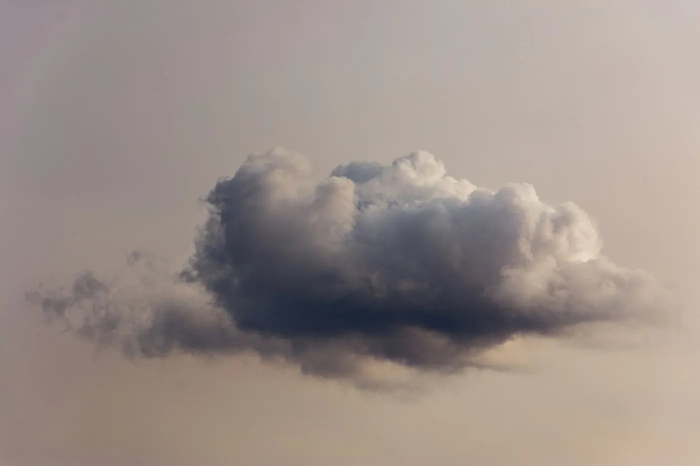 Single grey cloud in the sky against a neutral background.