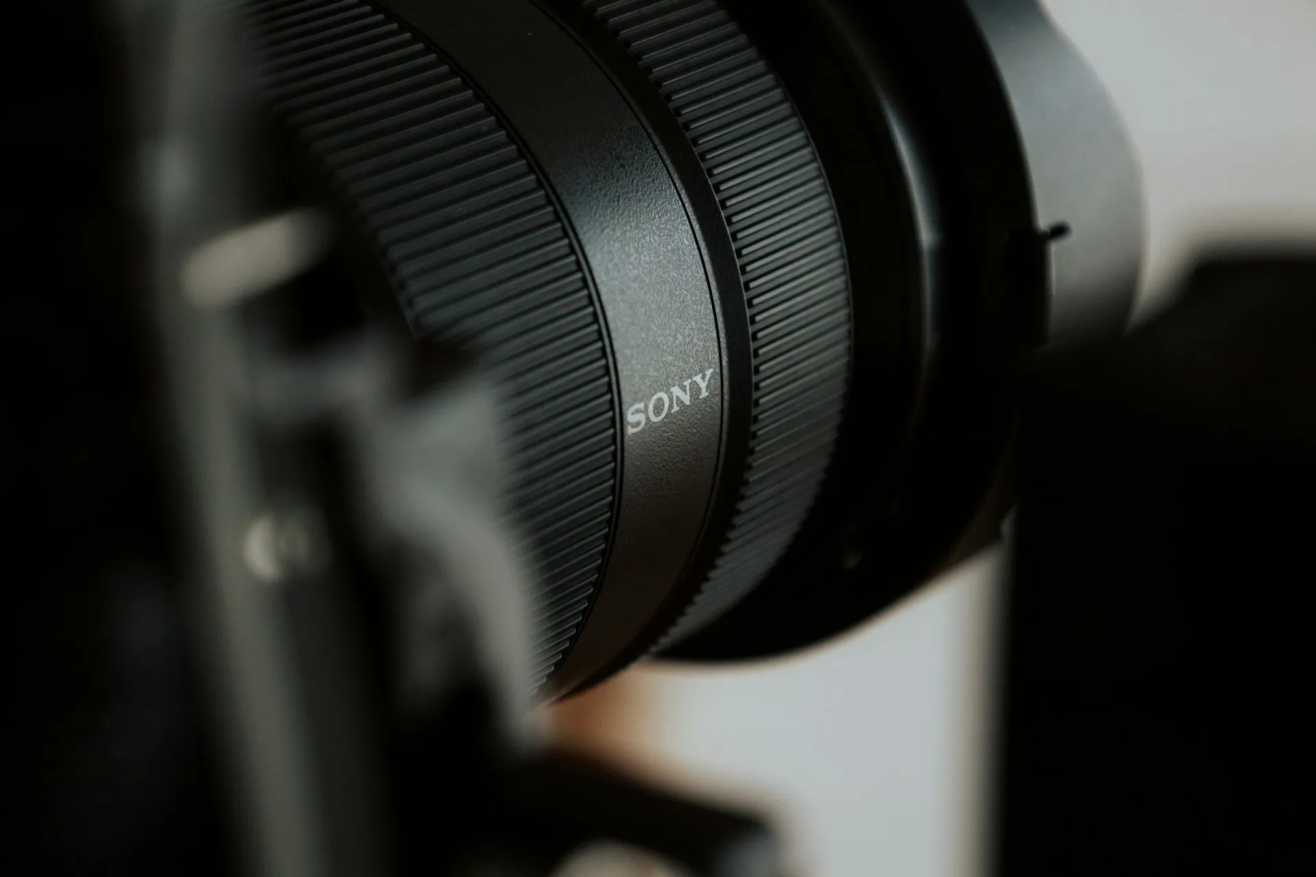 Close-up of a Sony camera lens mounted on a professional camera setup.