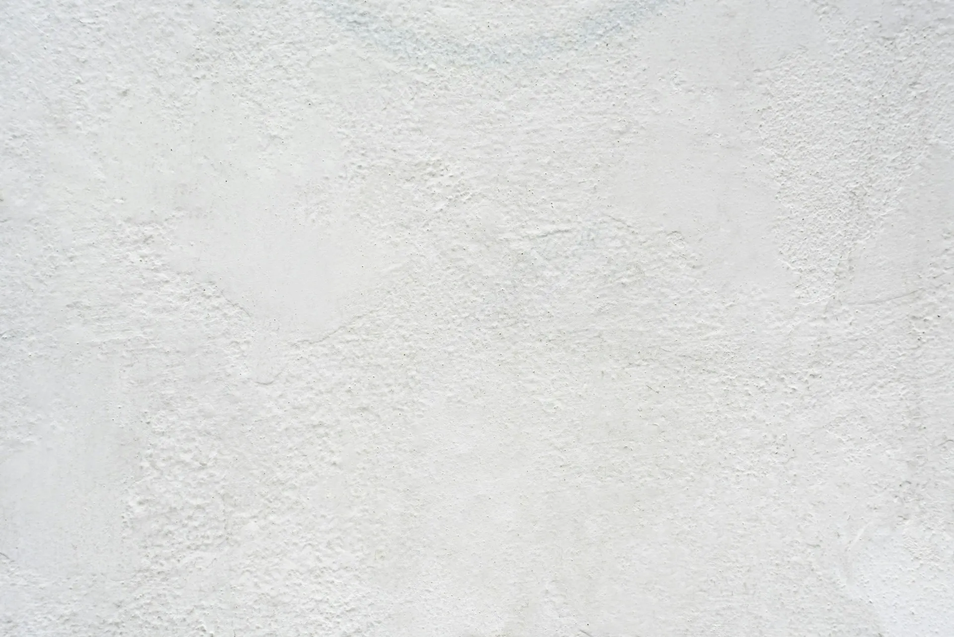 White textured background with a subtle plaster or concrete finish.