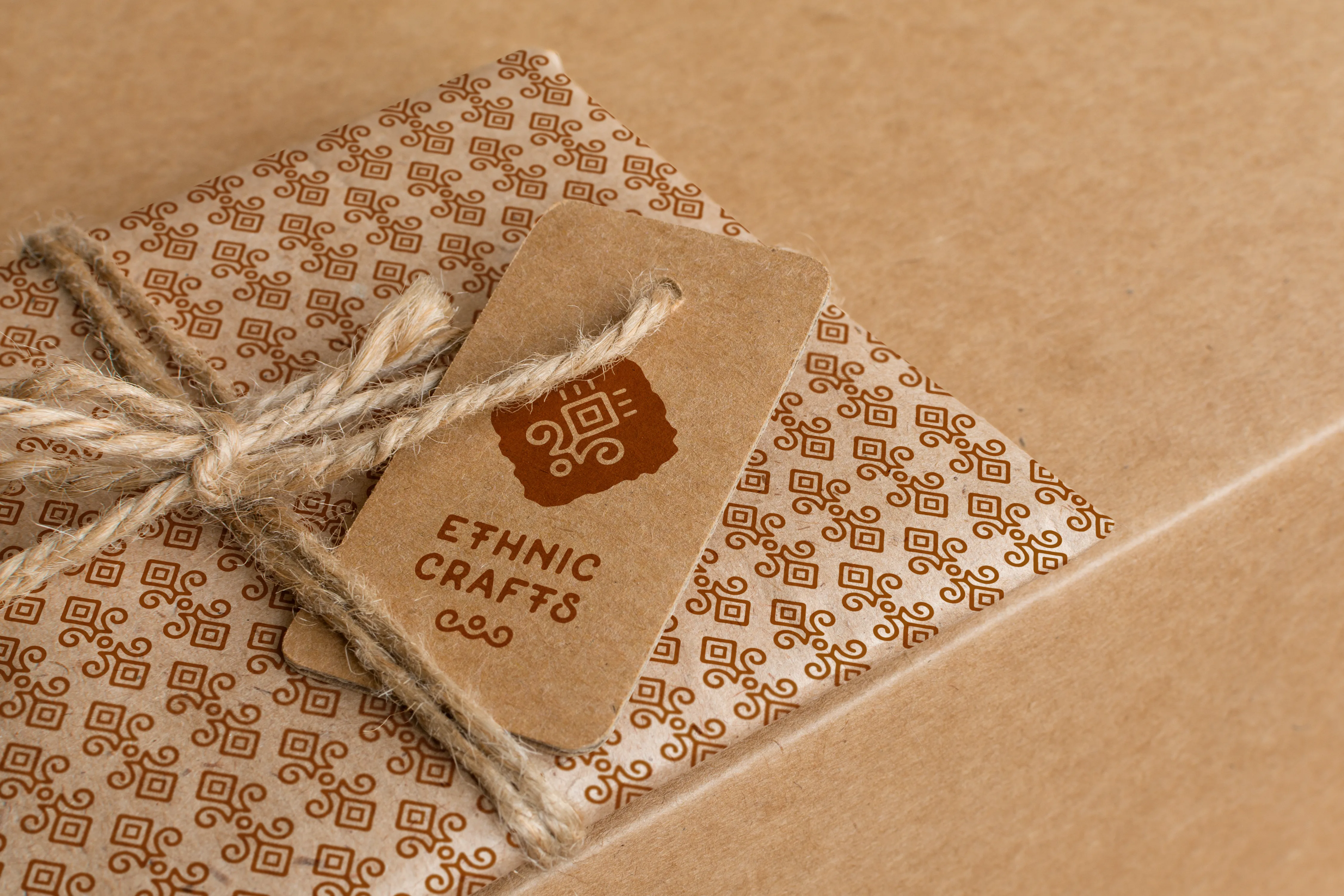 Packaging design for 'Ethnic Crafts' Close-up of a kraft paper package tied with twine, featuring a patterned wrap and a tag labeled “Ethnic Crafts” with a tribal-style logo.